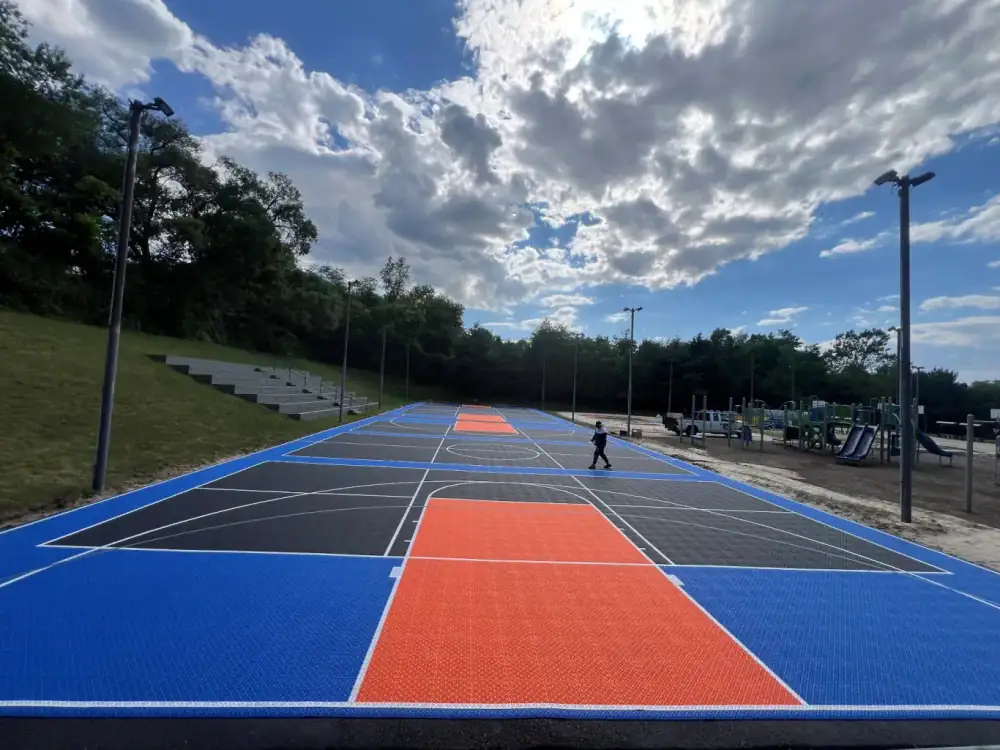 Outdoor camp court surfaced with modular court tiles
